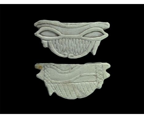 Late Period, 664-332 BC. A composition D-shaped amulet with addorsed wedjat motifs to one face with hatched panel, similar to