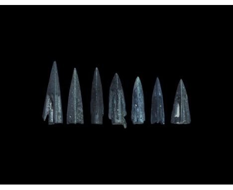 6th-4th century BC. A group of bronze triangular-section socketted arrowheads, two with barbs to the rear. 14 grams total, 20