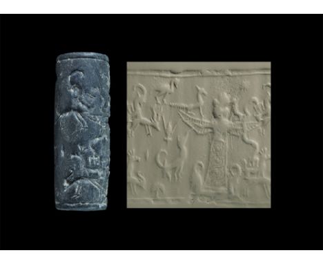 1400-1000 BC. A bitumen cylinder seal with standing goddess surrounded by animals; accompanied by a museum-quality impression