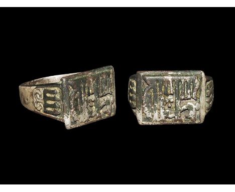 14th-15th century AD. A heavy broad flat-section silver hoop with expanding shoulders, plaque with bevelled edges, reserved K