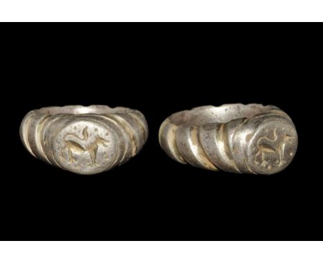 13th-14th century AD. A parcel-gilt silver D-section hoop with faux-twist detailing to the outer face, raised plaque with int