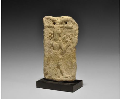 19th-18th century BC. A rectangular terracotta plaque with two holes below the upper edge; low-relief motif of the goddess Is