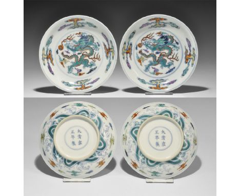 Ch'ing Dynasty, 1723-1735 AD. A pair of shallow porcelain dishes with white ground, decorated in enamels in the 'Doucai' styl