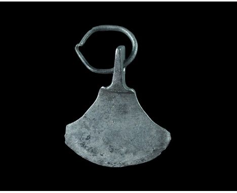 7th-10th century AD. A silver pendant in the form of a broad axe with suspension lug and silver ring. 1.33 grams, 20mm (3/4")
