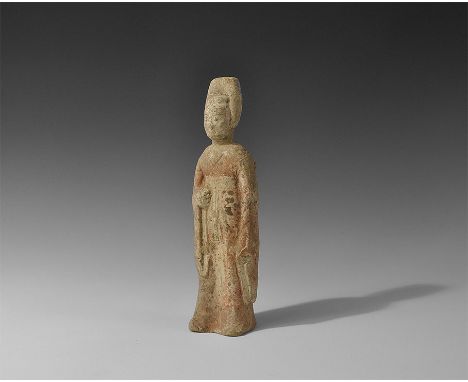 Northern Qi Dynasty, 550-577 AD. A hollow-formed ceramic figure of a standing robed female with tall headdress and broad sash