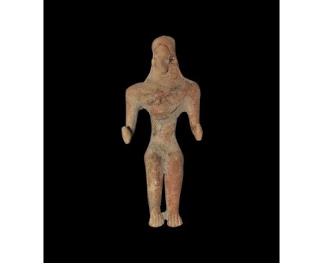 4th-2nd millennium BC. A ceramic setaed figure with arms flexed, conical head, plaque to the chest. 34 grams, 10.5cm (4 1/4")