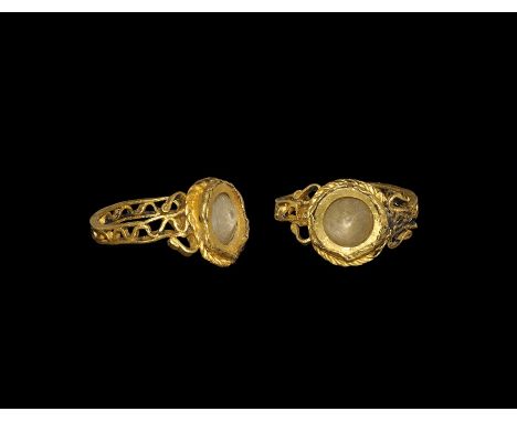 1st-2nd century AD. A gold openwork hoop formed as two straps and a corrugated band between, scrolls to the shoulders, discoi