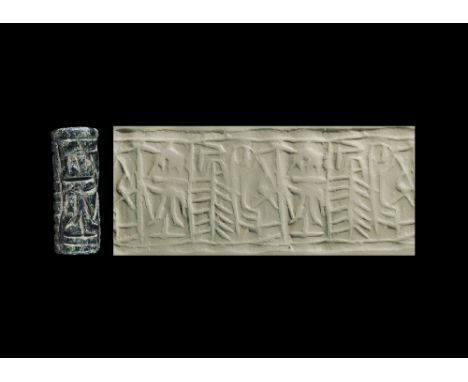 12th-11th century BC. A hardstone cylinder seal with the surface divided into hatched panels, accompanied by a museum-quality