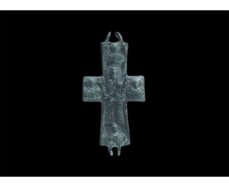 8th-12th century AD. A bronze cruciform pendant panel with hinge elements above and below, low-relief image of a robed figure