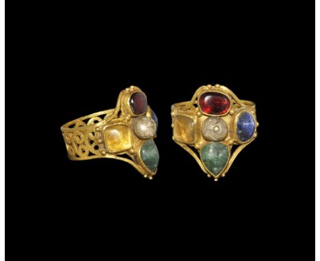 6th-8th century AD. A flat-section gold hoop with opus interrasile scrolls, piriform plaque with four cabochon gemstone inser