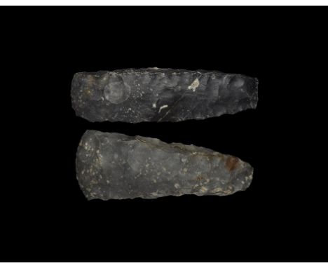 Neolithic, 5th-3rd millennium BC. Two knapped flint axes, rectangular in section, one with sqaured butt and lightly curved cu