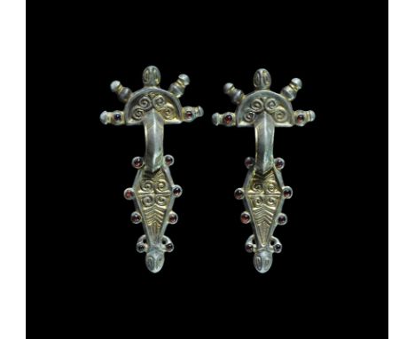 Late 5th century AD. A matched pair of silver-gilt bow brooches, each a D-shaped headplate with S-scroll ornament, four radia