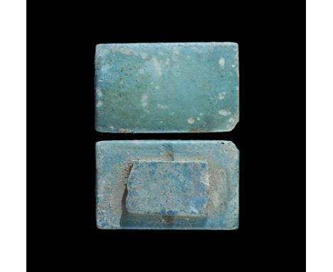 Old Kingdom, 2686-2181 BC. A rectangular glazed composition tile with slightly domed face, pierced rectangle to the reverse. 