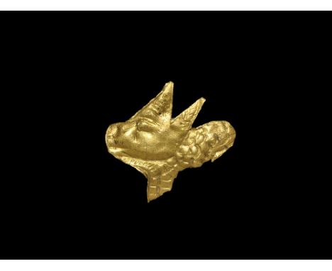 3rd-2nd millennium BC. A flat-section gold foil plaque of the head of a bull in profile with textured horns and body. 1.37 gr