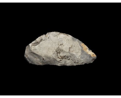 Neolithic, 3rd-2nd millennium BC. A knapped flint bifacial sickle knife with one straight and one curved edge; in a coarse gr