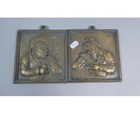 A Pair of Late 19th Century Square Brass Plaques Depicting Gents Smoking Pipe and Lady Taking Snuff, Each 14cm 