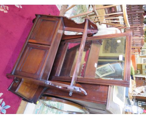 An Edwardian mahogany wall shelf with double doors and shaped sides, 59cm wide and a dressing table mirror with drawer suppor