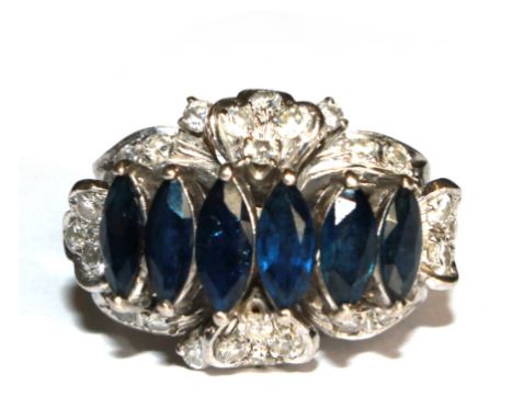 A diamond and six stone marquise blue stone ring (possibly sapphires) set in white metal