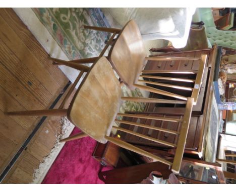 A pair of Ercol elm seated kitchen chairs with blue gilt labels