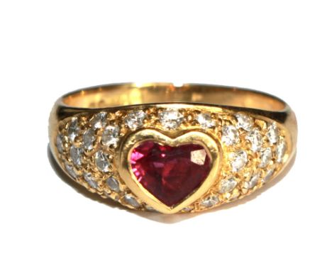 An 18 carat gold ring set with diamonds and a heart shaped red stone (possibly ruby)