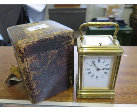 A brass carriage clock with white enamel dial, the repeating movement striking on a gong, as found, in original case, 16cm hi