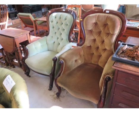 A pair of Victorian mahogany button back armchairs with cabriole legs and castors