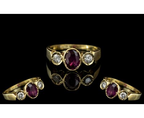 18ct Gold Attractive 3 Stone Ruby and Diamond Set Dress Ring. Marked 750 - 18ct to Interior of Shank. The Oval Shaped Faceted