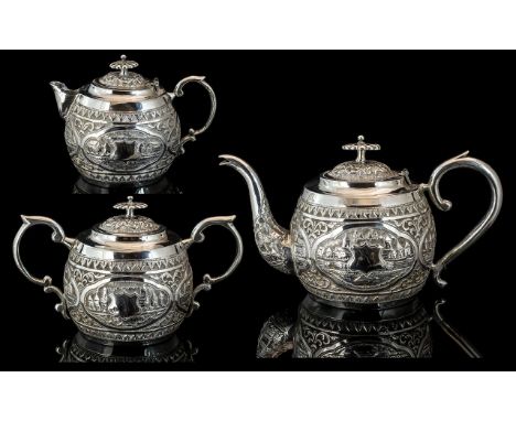 Victorian Period Excellent Quality Colonial Three Piece Silver Tea Service, decorated with embossed images of buildings, rive