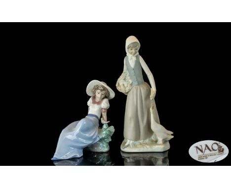 Two Nao Figurines, comprising  No. 26 'Girl with Goose', measures 10'' tall, and No. 01042 'Girl Reclining with Bird', measur