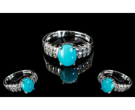 Turquoise and White Zircon Ring, an oval cut cabochon of over 2cts of the bright, matrix free, turquoise from the Sleeping Be