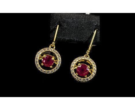 Ruby 'Moving Gemstone' Drop Earrings, with an unusual suspended setting for each 1.5ct, round cut, rich red ruby, causing the
