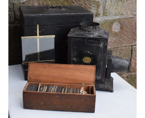 A cased Negretti and Zambra magic lantern in wooden box with a box of slides with examples such as Moreton Hall, architecture