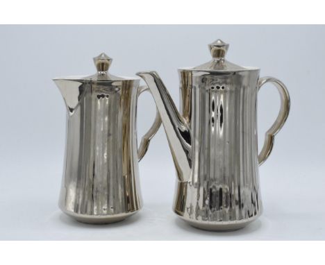 A pair of Royal Worcester silver pottery tea and coffee pots (2).  In good condition with no obvious damage or restoration.