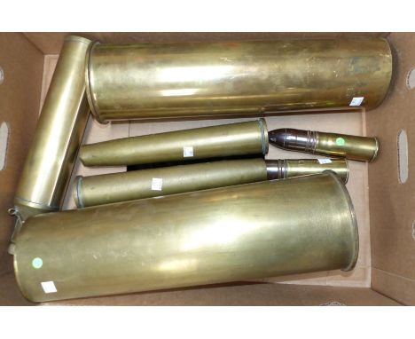 Two large brass shell cases; a brass powder flask