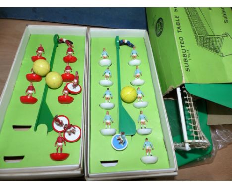 Two sets of Subbuteo table soccer teams in original boxes; 2 sets of goal posts and baize pitch