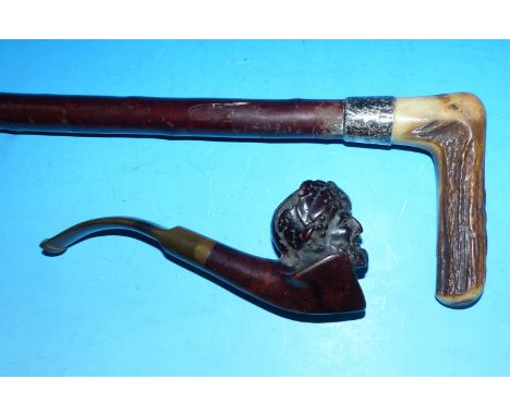 A Victorian cherrywood walking stick with silver band; a similar carved pipe