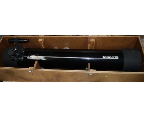 A Tasco reflecting telescope with 3 eye pieces, equatorial mount and tripod