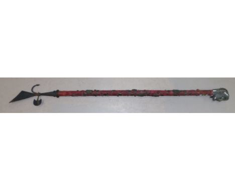 A brass mounted ceremonial axe with velvet covering, 62"