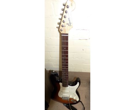 A Squier Strat by Fender electric guitar with Squier amplifier