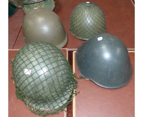 Four post WWII steel helmets