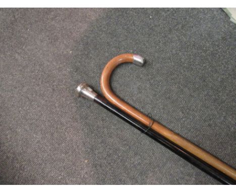 A silver handled walking stick and a cane with white metal knop, engraved "J.D. Shaw-Hamilton"