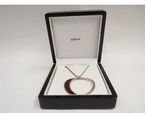 An Ortak pendant of modernistic form, dark red enamel detail, stamped 925 hung on a snake link chain, 40cm long, 13.8g boxed