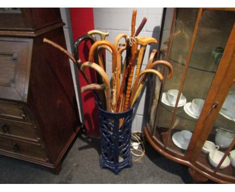 A cast metal stick stand with various sticks
