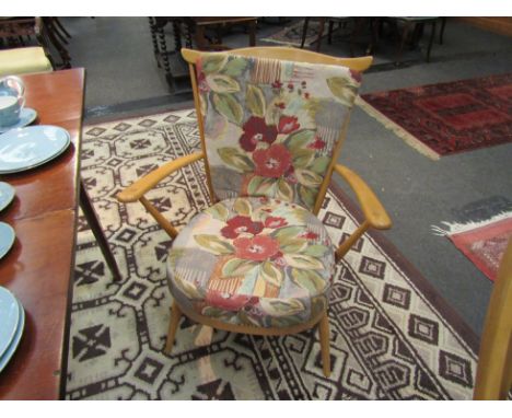 An Ercol armchair with stick back, removable cushions, splayed legs