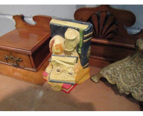 A cast metal doorstop in the form of books, globe, glasses and scroll, 20cm x 15cm  