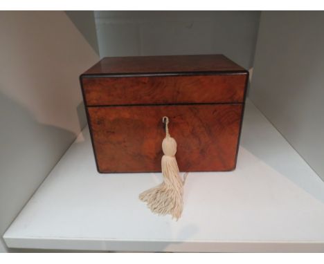 A Victorian walnut tea caddy with ebony banding, with key