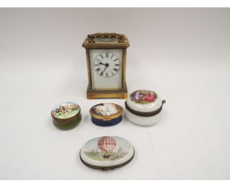A brass cased carriage clock together with four trinket pots 