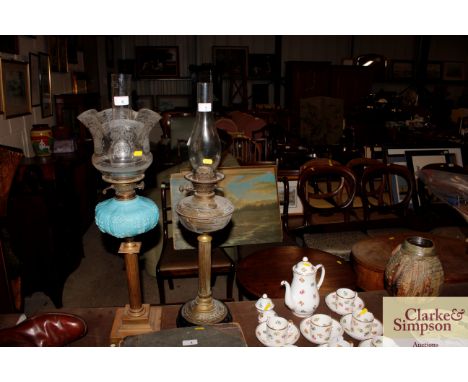 A brass oil lamp with glass chimney