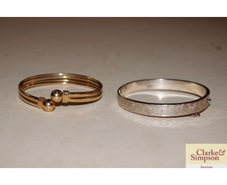 A 9ct gold bangle and silver bangle 