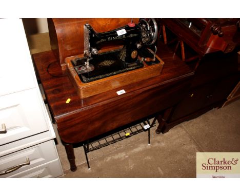 A 19th Century mahogany Pembroke table raised on ring turned and tapering supports 